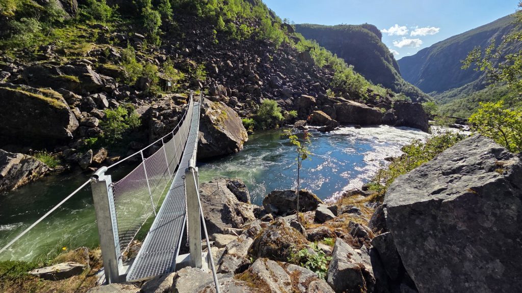 River with a steel bridge for hikers across.