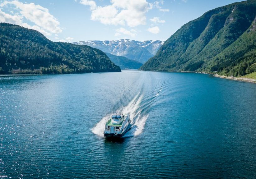A passenger boat sailing on the Hardangerfjord on a sunny summer day. 