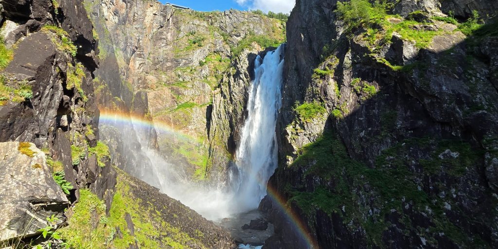 Vøringsfossen waterfall from below with rainbow